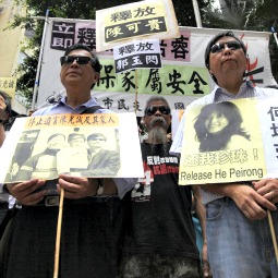 Protesters wearing sunglasses shout slogans in support of Chinese dissident Chen Guangcheng outside the Chinese liaison office in Hong Kong April 30.