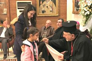 Patriarch Younan blesses a child in Aleppo, Syria. 