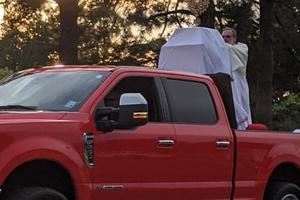 Monsignor Daniel Torres of Our Lady Queen of Heaven Catholic church holding the Blessed Sacrament. 