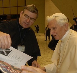 Father John Phalen presents a book of Rosary pledge names to Pope Benedict XVI.