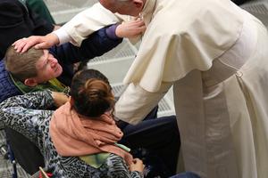 Pope Francis greets the sick while meeting with the Don Guanella charity organization (Guanellian Family) at the Paul VI audience hall on Nov. 12.