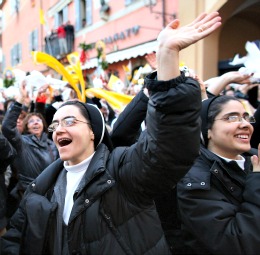 Women religious cheer as Pope Benedict XVI waves to pilgrims from the balcony of Castel Gandolfo, where the pope emeritus began his retirement Feb. 28.