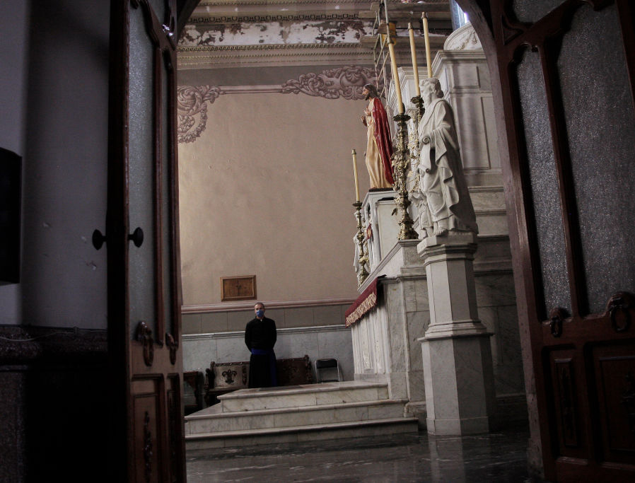 A priest stands alone June 11 in a church closed as a coronavirus preventative measure in Tepatitlán, Mexico.
