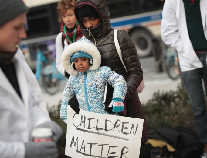 Melanie Lockridge and her 2-year-old daughter, Zariyah, attend a Dec. 14, 2017, rally hosted by University of Chicago medical students to call on Congress to reauthorize funding for the Children's Health Insurance Program (CHIP)  in Chicago. A total of 9 million children are enrolled in the program, which needs Congress to refund it. Lockeridge's two daughters have been enrolled in the program. 