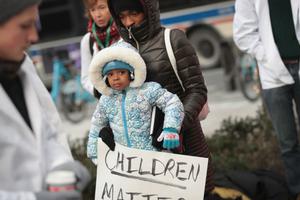 Melanie Lockridge and her 2-year-old daughter, Zariyah, attend a Dec. 14, 2017, rally hosted by University of Chicago medical students to call on Congress to reauthorize funding for the Children's Health Insurance Program (CHIP)  in Chicago. A total of 9 million children are enrolled in the program, which needs Congress to refund it. Lockeridge's two daughters have been enrolled in the program. 