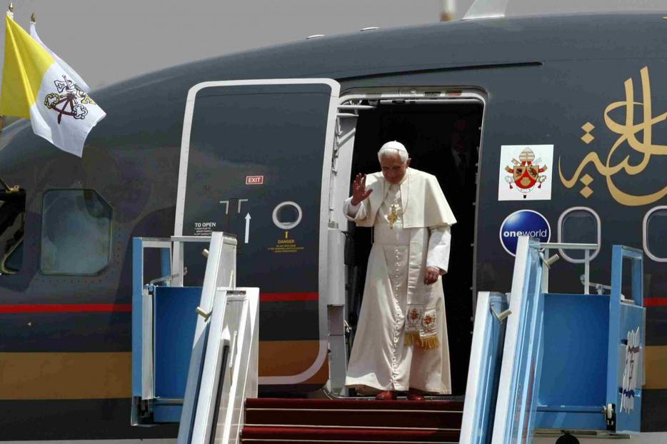 Benedict waves as he prepares to leave his plane upon his arrival at Ben-Gurion Airport today in Tel Aviv.