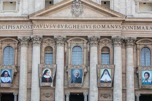 The official canonization banners of the five new saints hang in St. Peter's Square.
