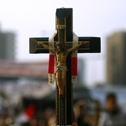 CHRISTIAN PRESENCE. A Christian supporter of pro-democracy actions in Egypt carries a crucifix amid the crowd in Tahrir Square in Cairo Feb. 9. Thousands of pro-democracy demonstrators in the square continued to protest the rule of Egyptian President Hosni Mubarak despite concessions announced by the government.