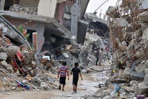 Children amid devastated buildings in Gaza. 