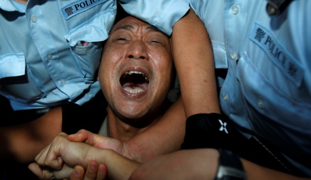 Hong Kong police arrest a pro-democracy protester Oct. 1 during a demonstration demanding China improve its human rights record, outside the Chinese liaison office in Hong Kong.