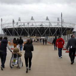 OLYMPIC SITE. People walk past the Olympic Stadium inside Olympic Park in London Dec. 4. 