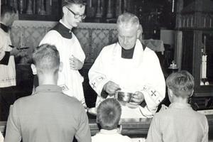 Father Walter Ciszek distributes Communion at Mass in the 1960s.