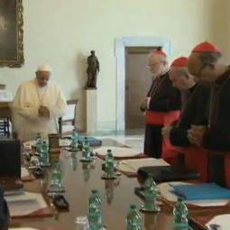 Pope Francis prays with the members of the council of cardinals during their initial meeting Oct. 1, 2013.