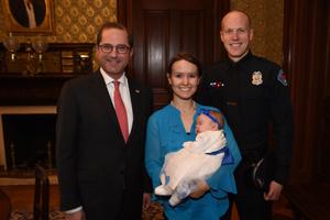 Sec. Alex Azar meets with Officer Ryan Holets of the Albuquerque Police Department and his wife, Rebecca, and their daughter Hope, whom they adopted, ahead of the State of the Union address Jan. 30. 