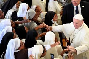 Pope Francis' shakes hands with nuns at the end of morning prayer at the Monastery of the Discalced Carmelites in Antananarivo, Madagascar, on Sept. 7. 
