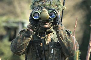 A member of the German Bundeswehr's 371st Armored Infantry Battalion looks through binoculaurs during a media event at the battalion's base on March 10 in Marienberg, Germany. NATO member states and many European nations are enhancing their military abilities as a reaction to Russian intervention in Ukraine.