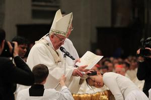 Pope Francis baptizes catechumens during the Easter Vigil Mass at St. Peter's Basilica on March 26, 2016.