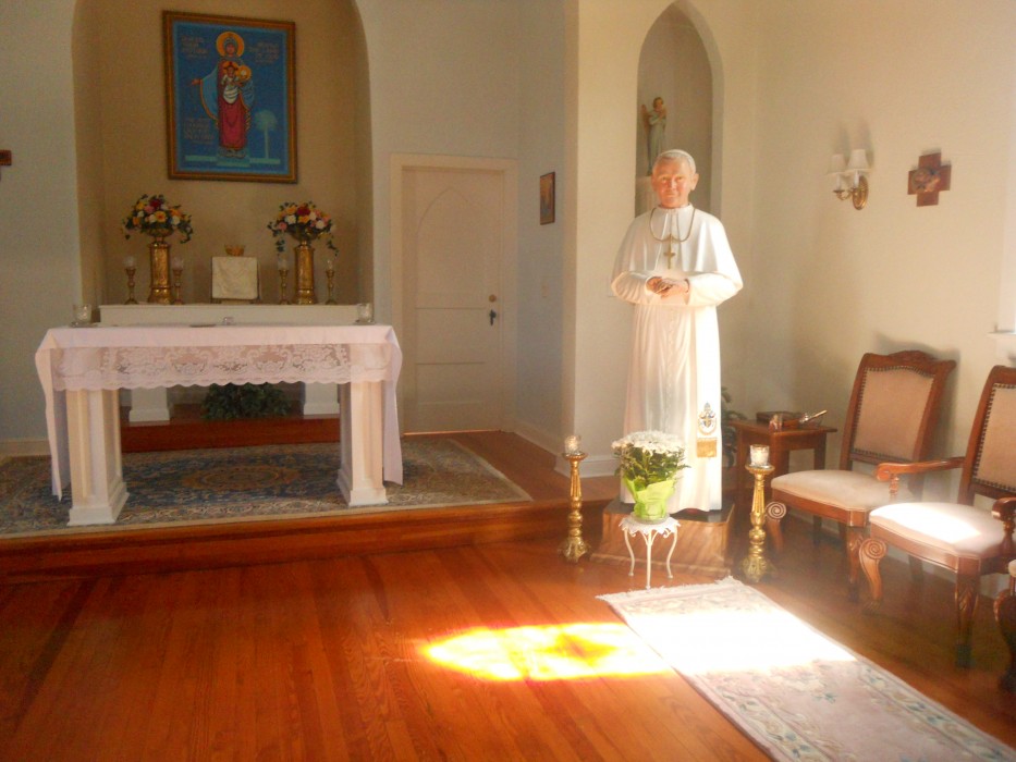 Soon-to-be-canonized John Paul II warmly "welcomes" pilgrims and visitors to Our Lady's shrine. Behind the altar is the icon of Our Lady of South Carolina, Mother of Joyful Hope.