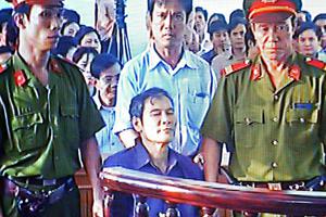 In this March 30, 2007 file image taken from a closed-circuit television, Father Nguyen Van Ly is seated in a courtroom in Hue, Vietnam. The country released the Catholic priest, who is one of its most prominent dissidents, prison in a move widely seen as a good will gesture before U.S. President Barack Obama visited. The Archdiocese of Hue reported on its webpage that it welcomed the return Friday of 70-year-old Father Ly from prison. He has been serving an eight-year prison term since March 2007 after being convicted of spreading propaganda against the state. 