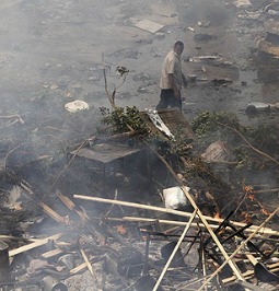 An Egyptian man stands amongst debris in the Nasr City district on Aug. 14 in Cairo.
