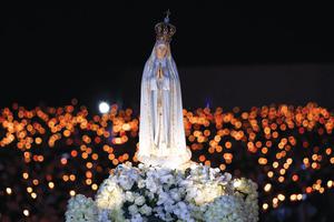 Above, a prayer vigil May 12 at the Shrine of Our Lady of Fatima in Portugal in preparation for the 100th anniversary of the Fatima apparitions May 13. Below, images of the faithful observing the Oct. 13, 1917, 'Miracle of the Sun.'

