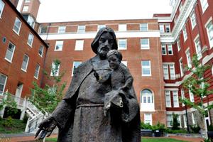 A Jesuit statue is seen in front of Freedom Hall, formerly named Mulledy Hall, on the Georgetown University campus on Sept. 1 in Washington. After renaming the Mulledy and McSherry buildings at Georgetown University temporarily Freedom Hall and Remembrance Hall, Georgetown University will give preference in admissions to the descendants of slaves owned by the Maryland Jesuits as part of its effort to atone for profiting from the sale of enslaved people.