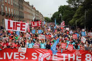 A large crowd gathers before the main stage on Dublin's Merrion Square.