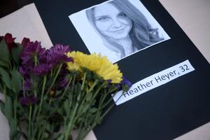 A portrait of Heather Heyer, who was killed when a vehicle drove through counterprotesters in Charlottesville, Virginia, lies on a table with flowers during a vigil on the campus of the University of Southern Mississippi in Hattiesburg Aug. 14. The rally was held in response to a white nationalist rally held in Charlottesville over the weekend. 