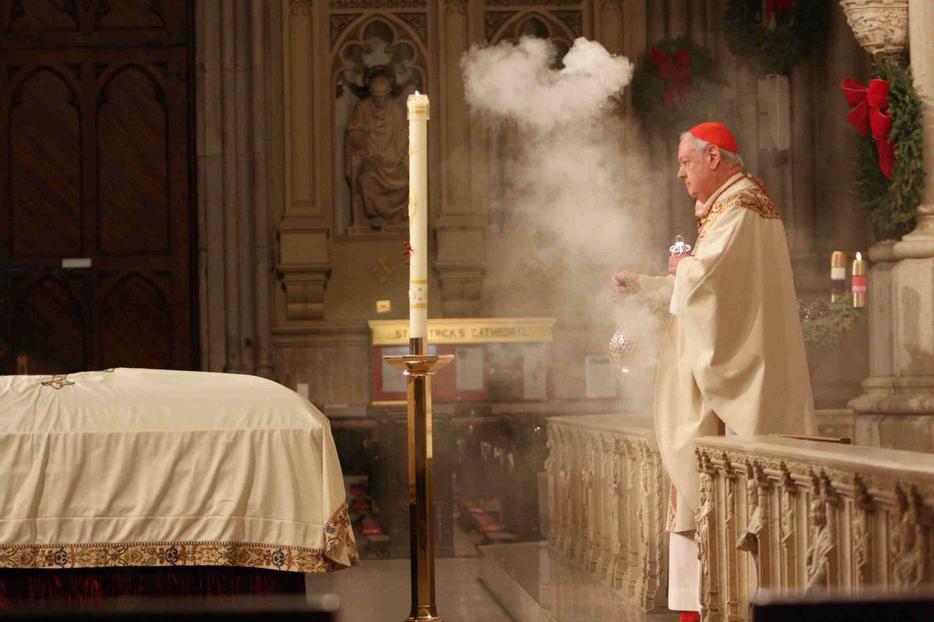 Cardinal Egan incenses the casket of Cardinal Dulles.
