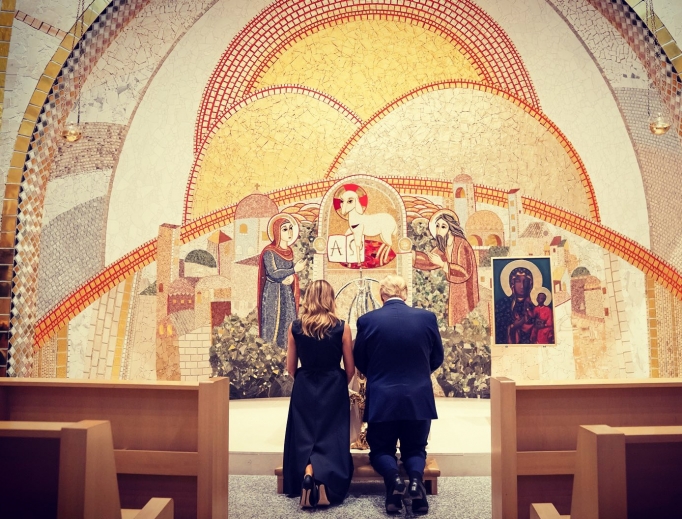 President Donald Trump and first lady Melania Trump kneel in front of a first-class relic of St. John Paul II at the St. John Paul II National Shrine on June 2.