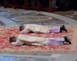 Archbishops Charles Brown and Marek Solczynski lay prostrate before Pope Benedict XVI at their episcopal ordinations in St. Peter's Basilica.