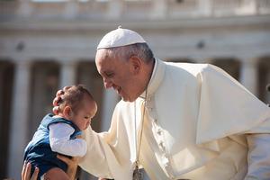 The Pope greets a baby during his general audience on Aug. 26.
