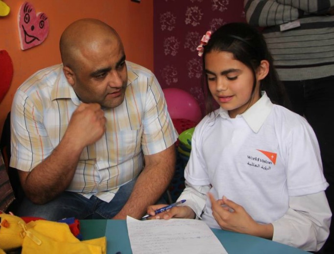 Mohammed Halabi, World Vision’s operations manager in Gaza, speaks with a child.