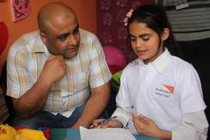 Mohammed Halabi, World Vision’s operations manager in Gaza, speaks with a child.