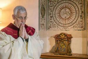 Father Arturo Sosa Abascal, superior general of the Society of Jesus, prepares to say Mass at the Church of the Gesu in Rome Oct. 15.
