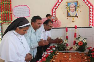 Above, Samandar Singh (center), flanked by Sister Selmy and Stephen, sister and elder brother of Sister Rani Maria, prays at the tomb of Sister Rani on Feb. 25, 2015, the 20th anniversary of her death.
