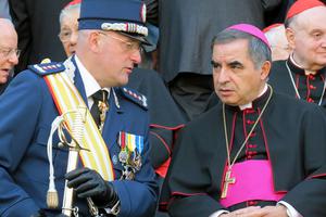 Domenico Giani and then-Archbishop Angelo Becciu attend the Gendarmes’ parade at the Vatican for the feast of St. Michael the Archangel on Oct. 5, 2012.
