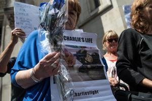 Supporters of Chris Gard and Connie Yates, the parents of terminally ill baby Charlie Gard, take part in a demonstration outside the U.K. High Court as Gard and Yates attend a case relating to their son on July 10. 