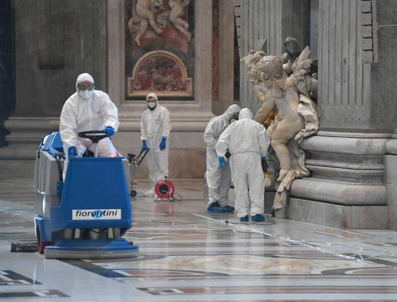 Workers sanitize St. Peter's Basilica May 15 in preparation for the resumption of public ceremonies.