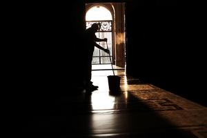 A man cleans the floor at St. Peter's Basilica at dawn. [Photo Illustration]