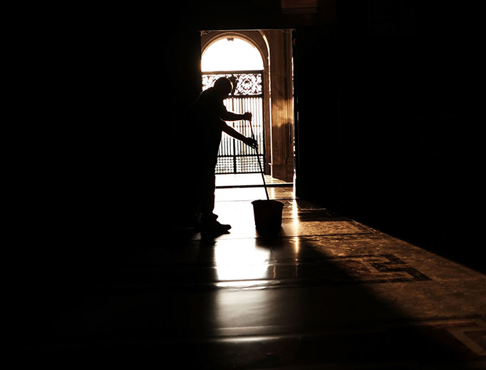 A man cleans the floor at St. Peter's Basilica at dawn. [Photo Illustration]