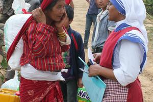 A Missionaries of Charity nun delivers earthquake relief aid on May 16 to residents in Khani Dhanda, Nepal.