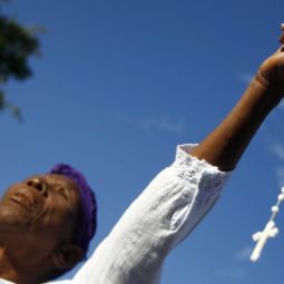 PRAYING FOR HAITI. A woman holding a rosary prays during a Mass outside the Cathedral of Our Lady of the Assumption in Port-au-Prince, Haiti, Jan. 12. The cathedral was destroyed in the January 2010 earthquake.