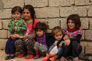  Refugee children huddle against a wall at the Sharia Al Haman Hope Refugee Camp in Duhok, Iraq, on March 28, 2015.