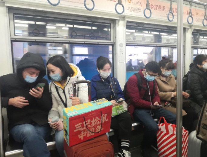 Passengers wear masks on the subway in Hong Kong, January 23, 2020. 