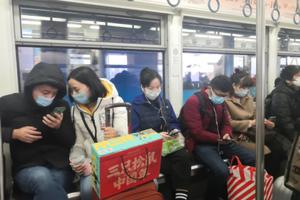 Passengers wear masks on the subway in Hong Kong, January 23, 2020. 