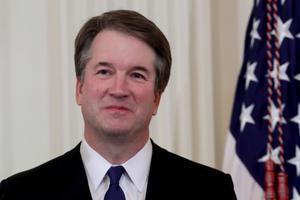U.S. Circuit Judge Brett Kavanaugh looks on as U.S. President Donald Trump introduces him as his nominee to the U.S. Supreme Court during an event in the East Room of the White House July 9. Pending confirmation by the U.S. Senate, Judge Kavanaugh would succeed Associate Justice Anthony Kennedy, 81, who is retiring after 30 years of service on the high court. 
