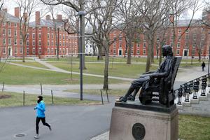 A runner crosses Harvard Yard on March 23, 2020 in Cambridge, Massachusetts.