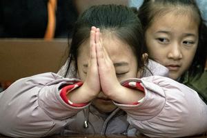 Children attend Christmas Eve Mass in Beijing on Dec. 24, 2019.
