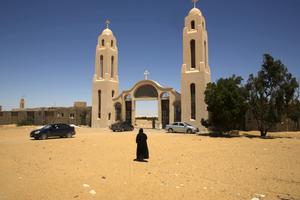 A priest walks in front of St. Samuel the Confessor Monastery, about 140 miles south of Cairo, Egypt, May 27. Masked gunmen ambushed a bus carrying Coptic Christians on their way to the monastery on Friday, killing 29 people.